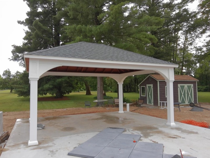 White pavilion over a new patio, built by Classic Fence